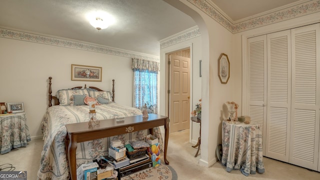 carpeted bedroom featuring a closet and ornamental molding