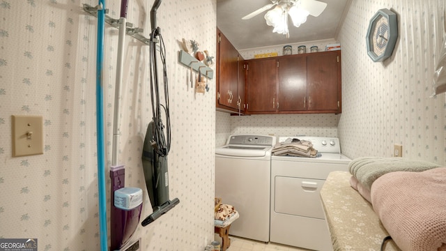 laundry room featuring ceiling fan, crown molding, washing machine and clothes dryer, and cabinets