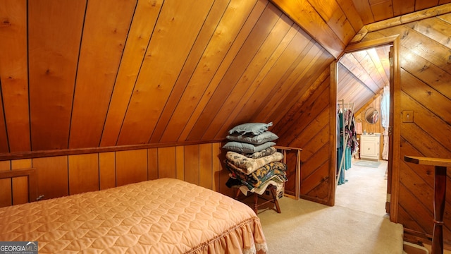 bedroom featuring light carpet, wood ceiling, vaulted ceiling, and wooden walls