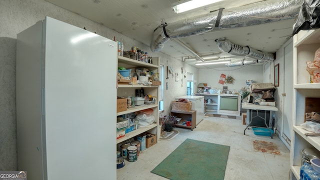 interior space with a workshop area and white refrigerator