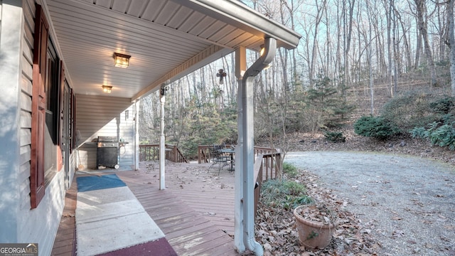 wooden terrace with a grill