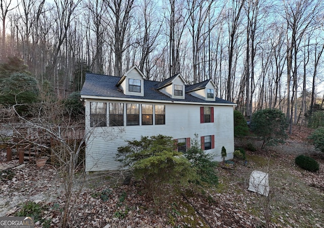 view of side of home featuring a sunroom