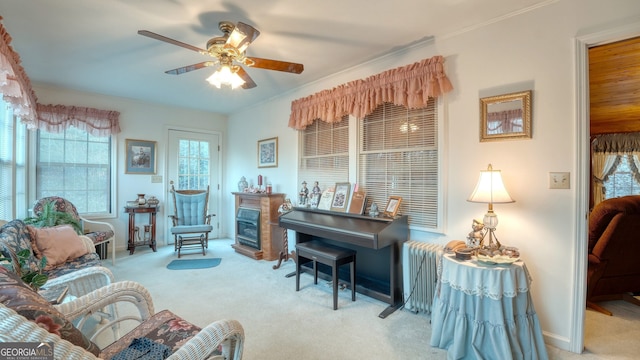 living area featuring ceiling fan and light colored carpet