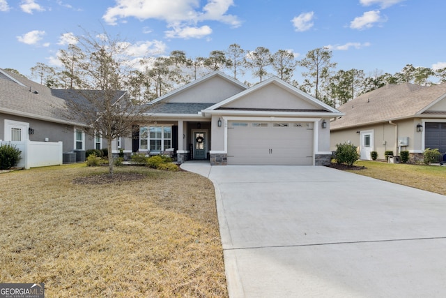 ranch-style house featuring central AC unit, a garage, and a front yard