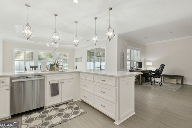 kitchen featuring white cabinetry, stainless steel dishwasher, decorative light fixtures, and sink