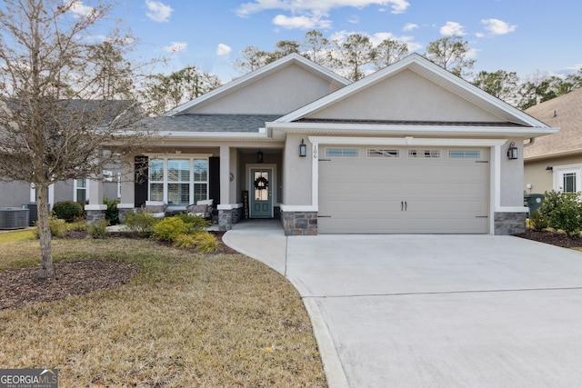 view of front of house with a front yard, a garage, and central AC