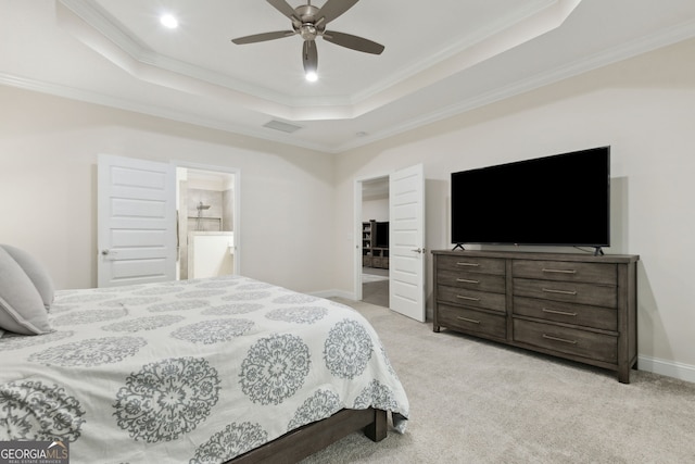 carpeted bedroom with ceiling fan, connected bathroom, ornamental molding, and a raised ceiling