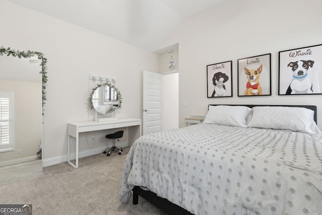 carpeted bedroom featuring lofted ceiling