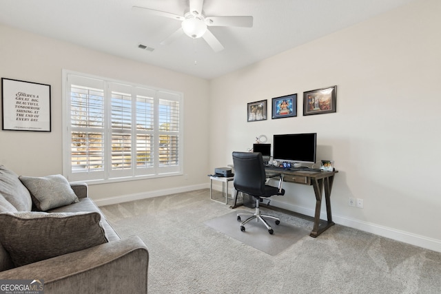 carpeted home office with ceiling fan