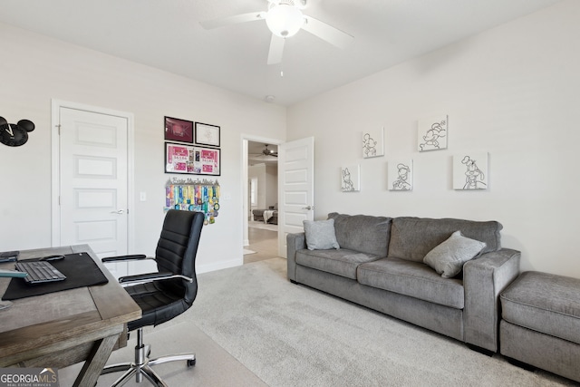 carpeted home office featuring ceiling fan