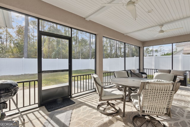 sunroom / solarium featuring ceiling fan