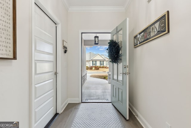 doorway to outside with ornamental molding