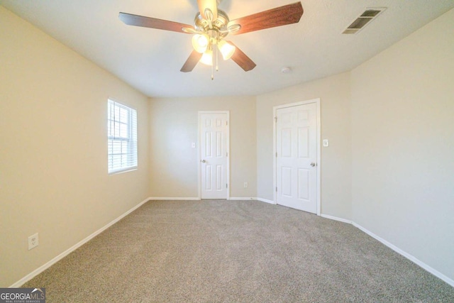 spare room with carpet floors and ceiling fan