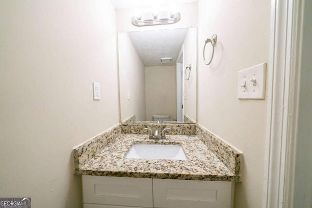 bathroom with toilet and vanity