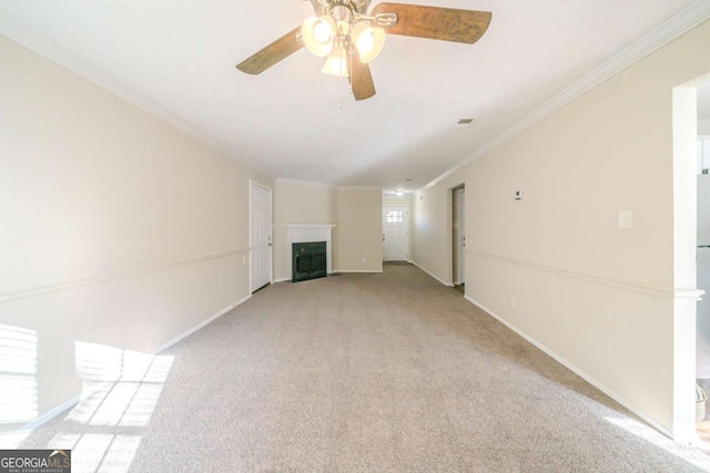 unfurnished living room featuring light carpet, ceiling fan, and ornamental molding