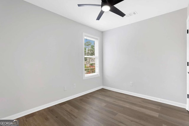 empty room featuring ceiling fan and dark hardwood / wood-style floors