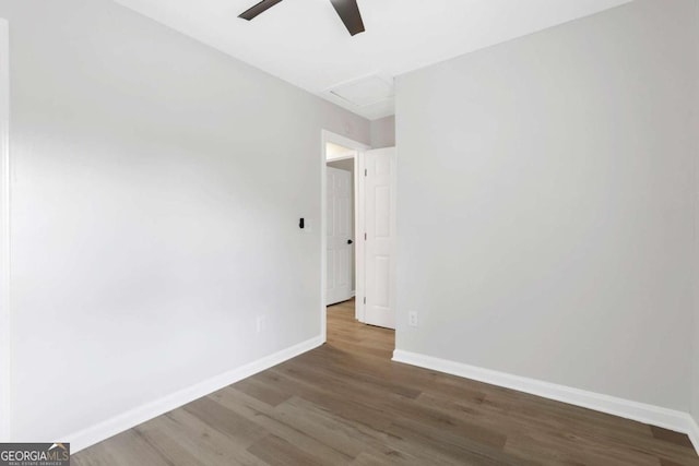 unfurnished room with ceiling fan and dark wood-type flooring