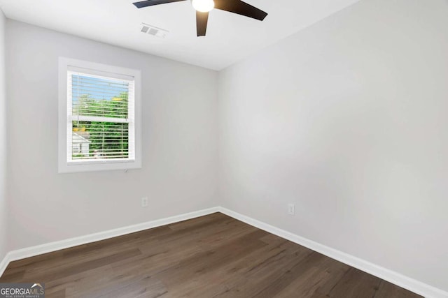 empty room with ceiling fan and dark wood-type flooring