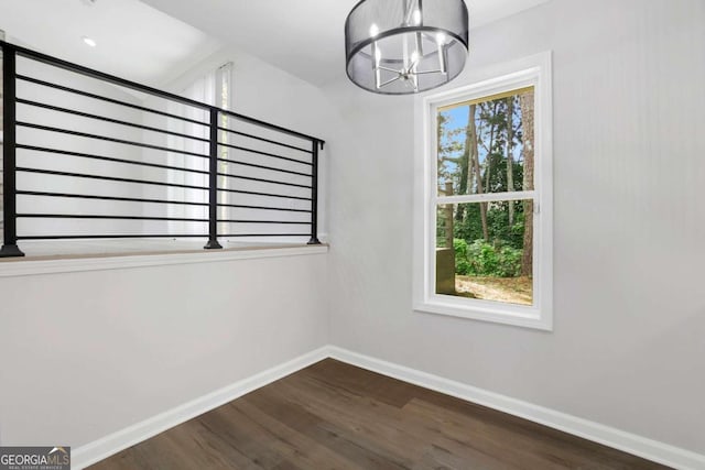 interior space with dark hardwood / wood-style flooring and a notable chandelier