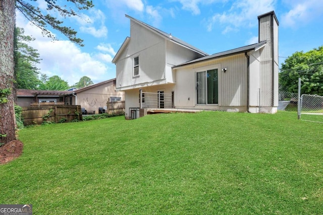 rear view of house featuring a lawn