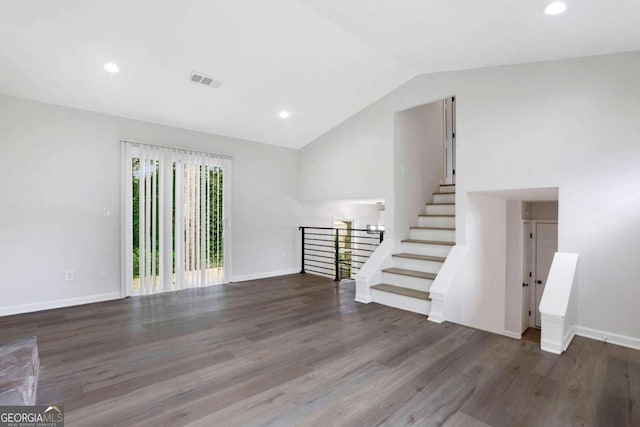 empty room with dark hardwood / wood-style floors and vaulted ceiling