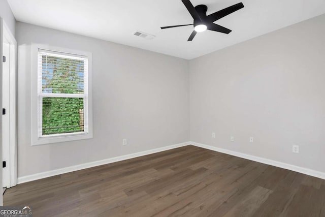 empty room with ceiling fan and dark hardwood / wood-style floors