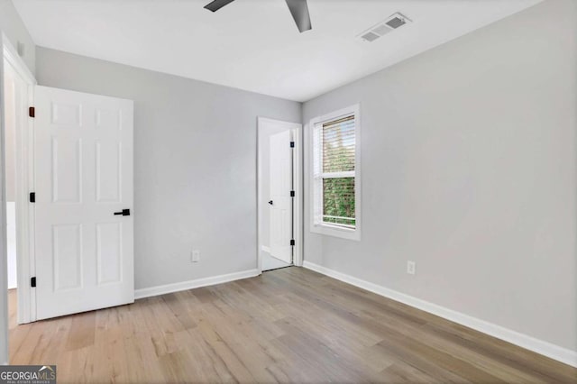 unfurnished bedroom with ceiling fan and light wood-type flooring