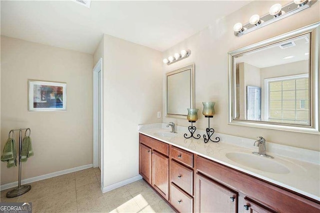 bathroom with tile patterned floors and vanity