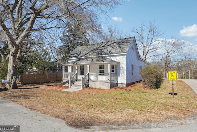 bungalow-style house featuring a front lawn and a porch