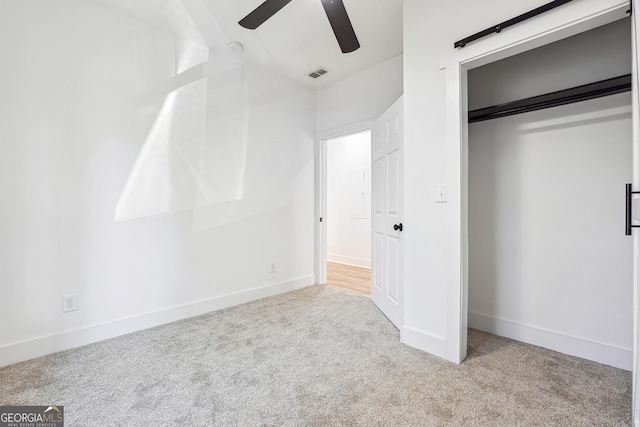 unfurnished bedroom featuring ceiling fan, a closet, and light colored carpet