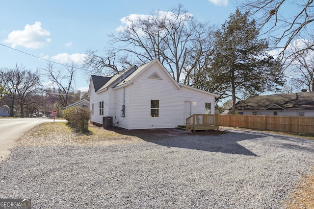 view of side of home featuring central AC