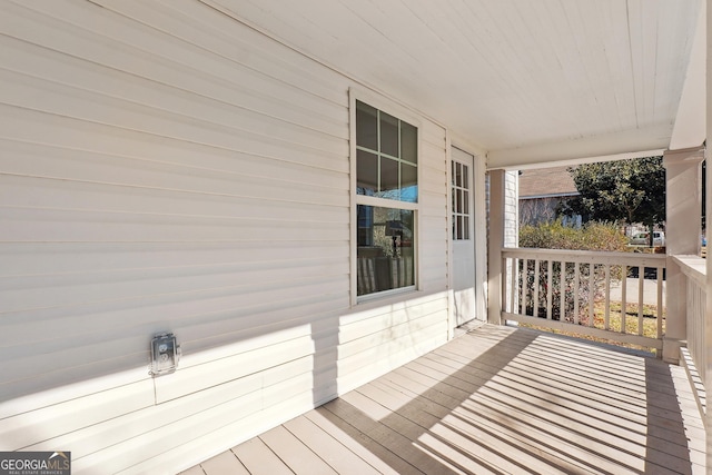 wooden terrace featuring covered porch