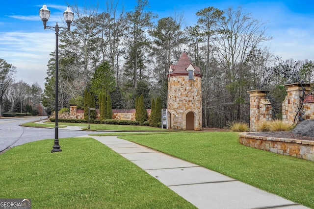 view of property's community with a lawn