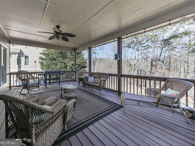 deck with ceiling fan and an outdoor living space