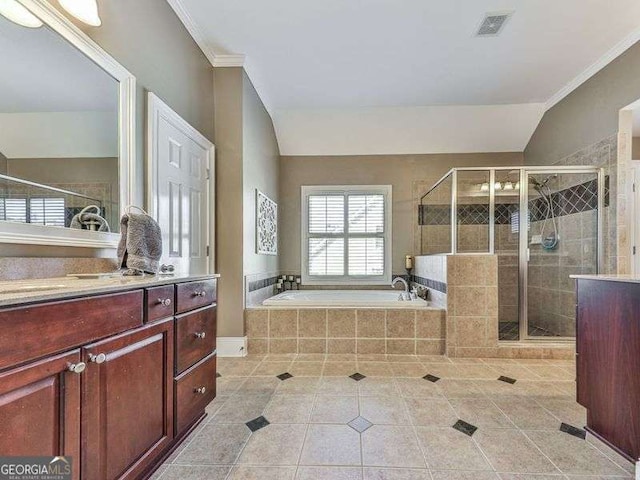 bathroom with shower with separate bathtub, vanity, lofted ceiling, and tile patterned flooring