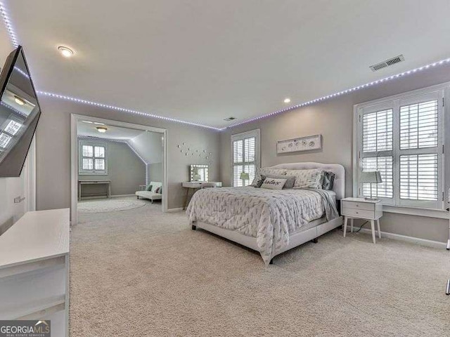 carpeted bedroom featuring multiple windows