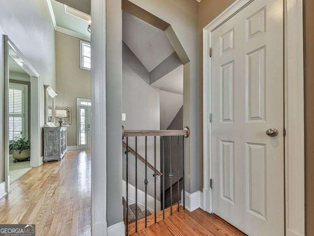 interior space featuring ornamental molding and light wood-type flooring