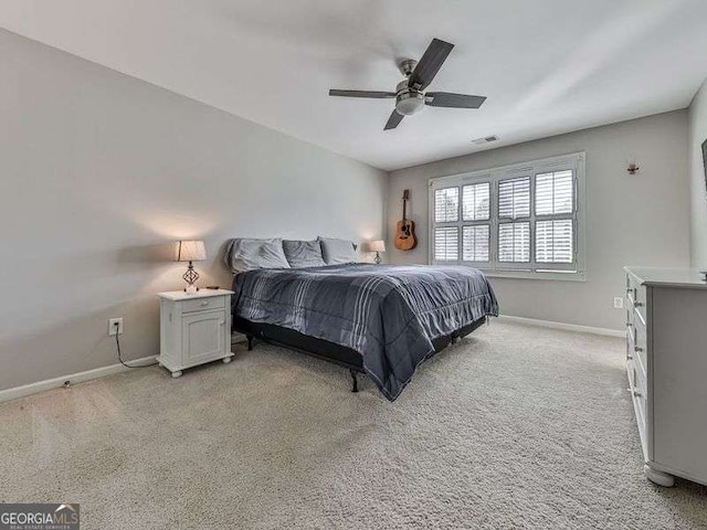 bedroom featuring a ceiling fan, baseboards, and light carpet