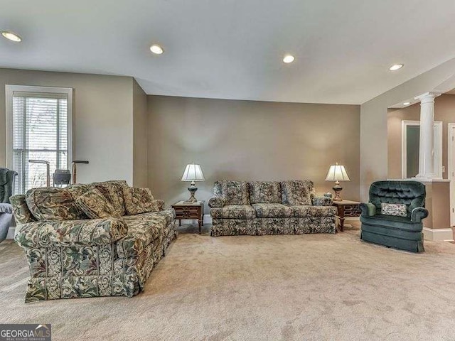 living room with carpet floors and ornate columns