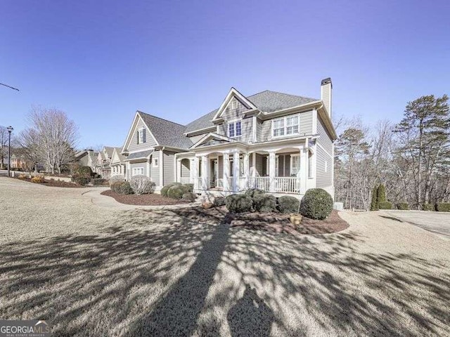 view of front of property with covered porch and a garage