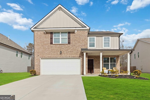 view of front of house with a garage, a front yard, and covered porch