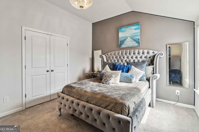 carpeted bedroom with lofted ceiling and a closet