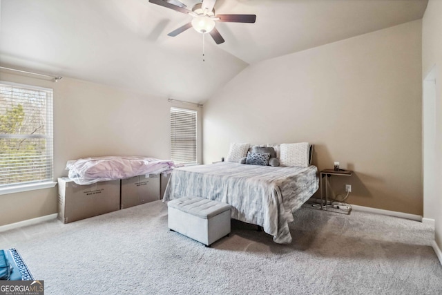 bedroom featuring vaulted ceiling, light colored carpet, and ceiling fan