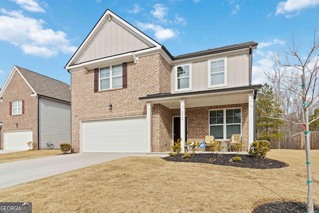 view of front of house with a garage, a front yard, and covered porch