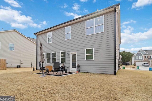 back of house featuring a yard and a patio area