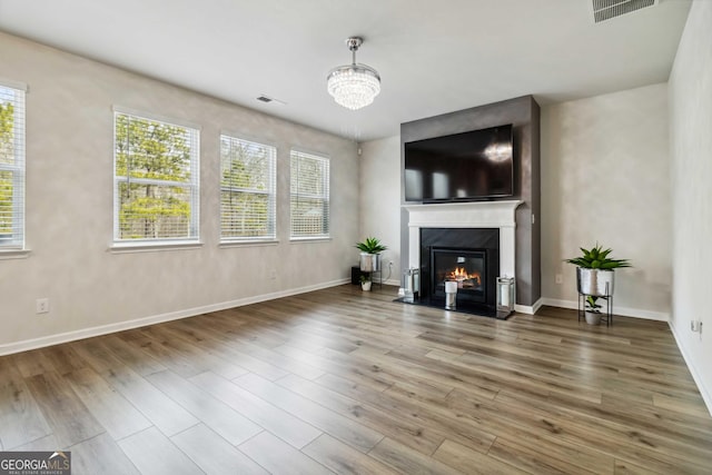 living room with hardwood / wood-style flooring and a notable chandelier