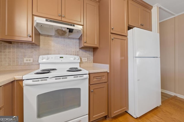 kitchen with backsplash, light hardwood / wood-style flooring, and white appliances