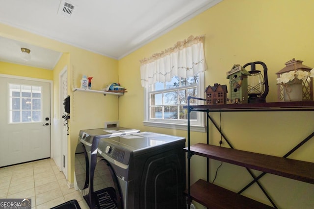 laundry room with light tile patterned floors and washer and dryer