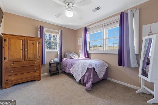 bedroom with ceiling fan, light colored carpet, and multiple windows