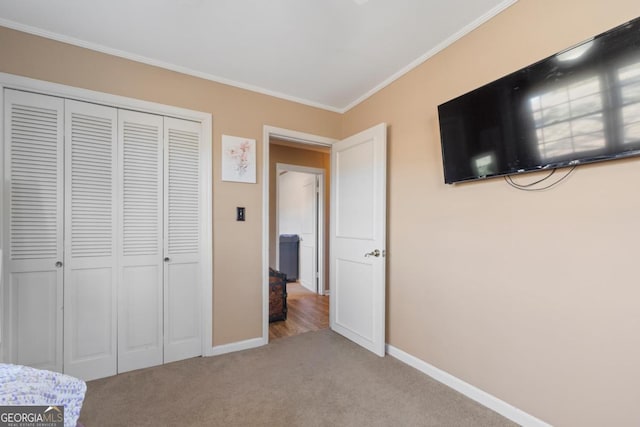 unfurnished bedroom with light colored carpet, a closet, and crown molding